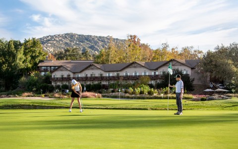 a man and woman playing golf