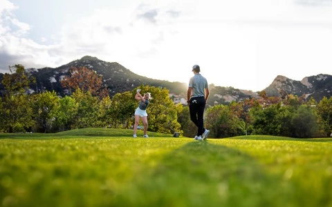 a man and woman playing golf