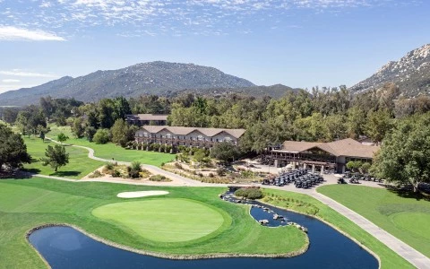 a golf course with a river and a building