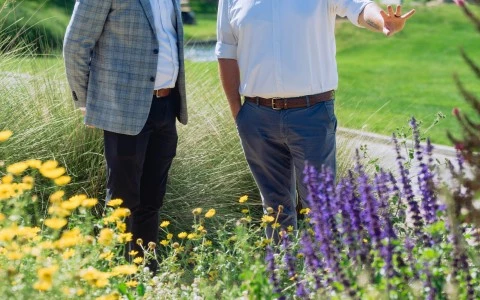 two men standing in a garden
