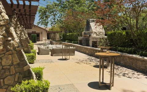 a patio with tables and chairs