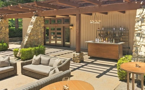 a patio with a bar and a table