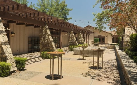 a patio with tables and chairs