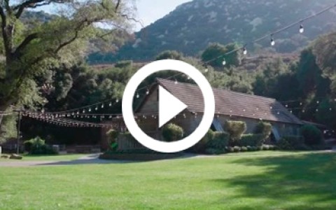 a video play button over a house