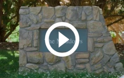 a stone sign with a play button