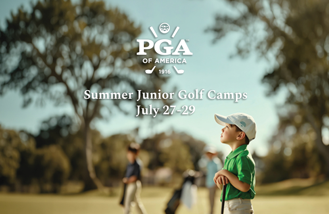 a boy standing on a golf course