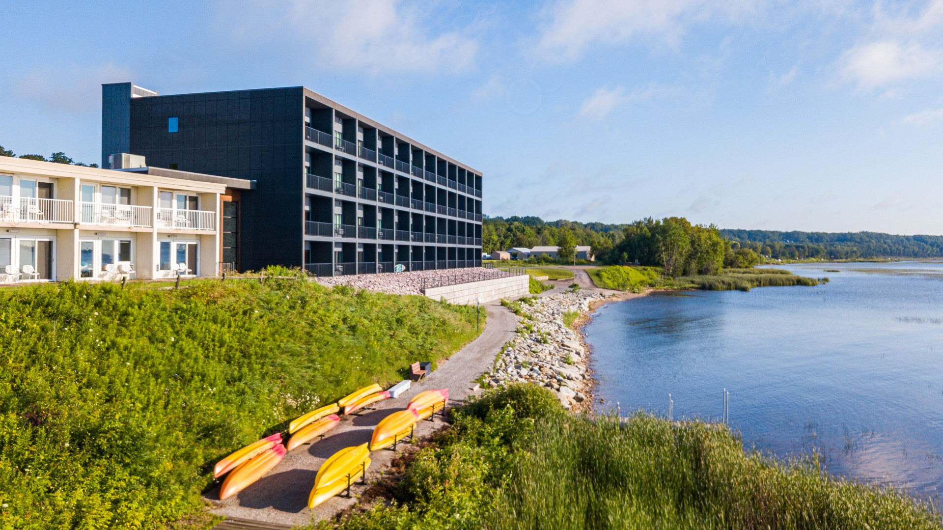 a building with a body of water and kayaks