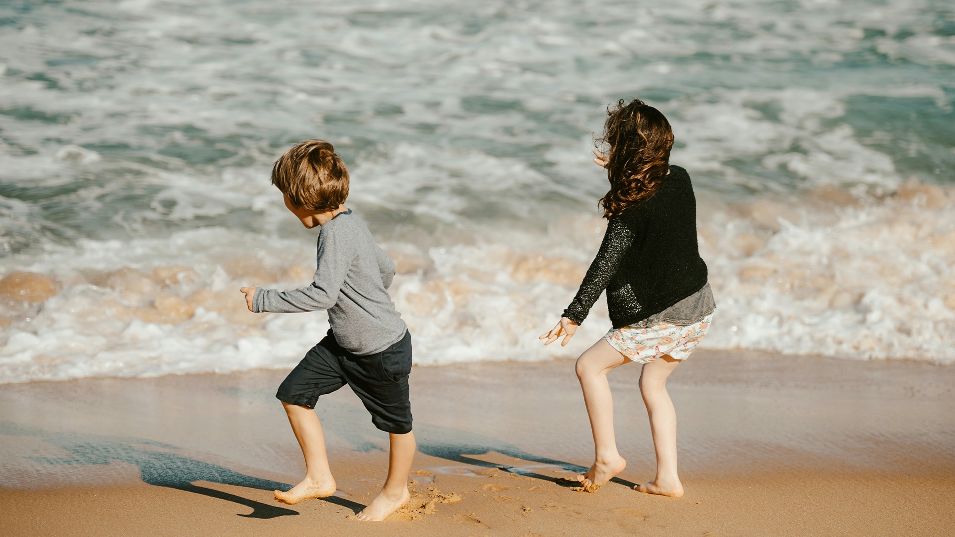 two children playing on the beach