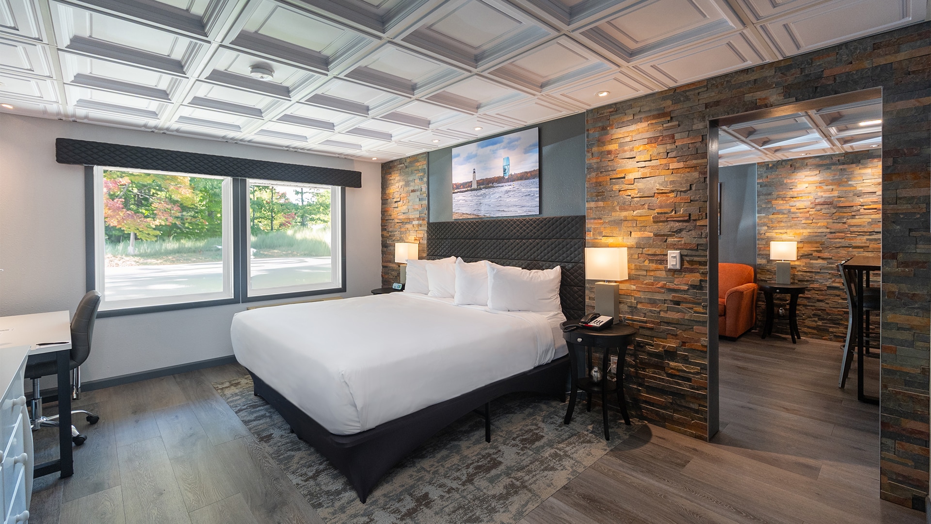 a room with a bed and a stone wall