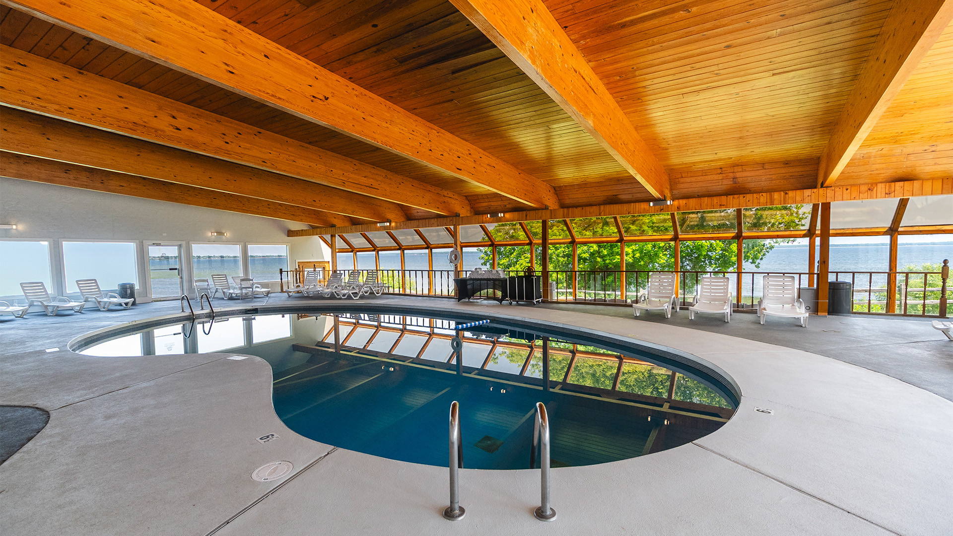 a indoor pool with a wooden ceiling