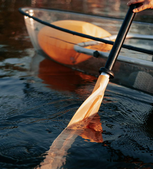 a person holding a paddle in a boat