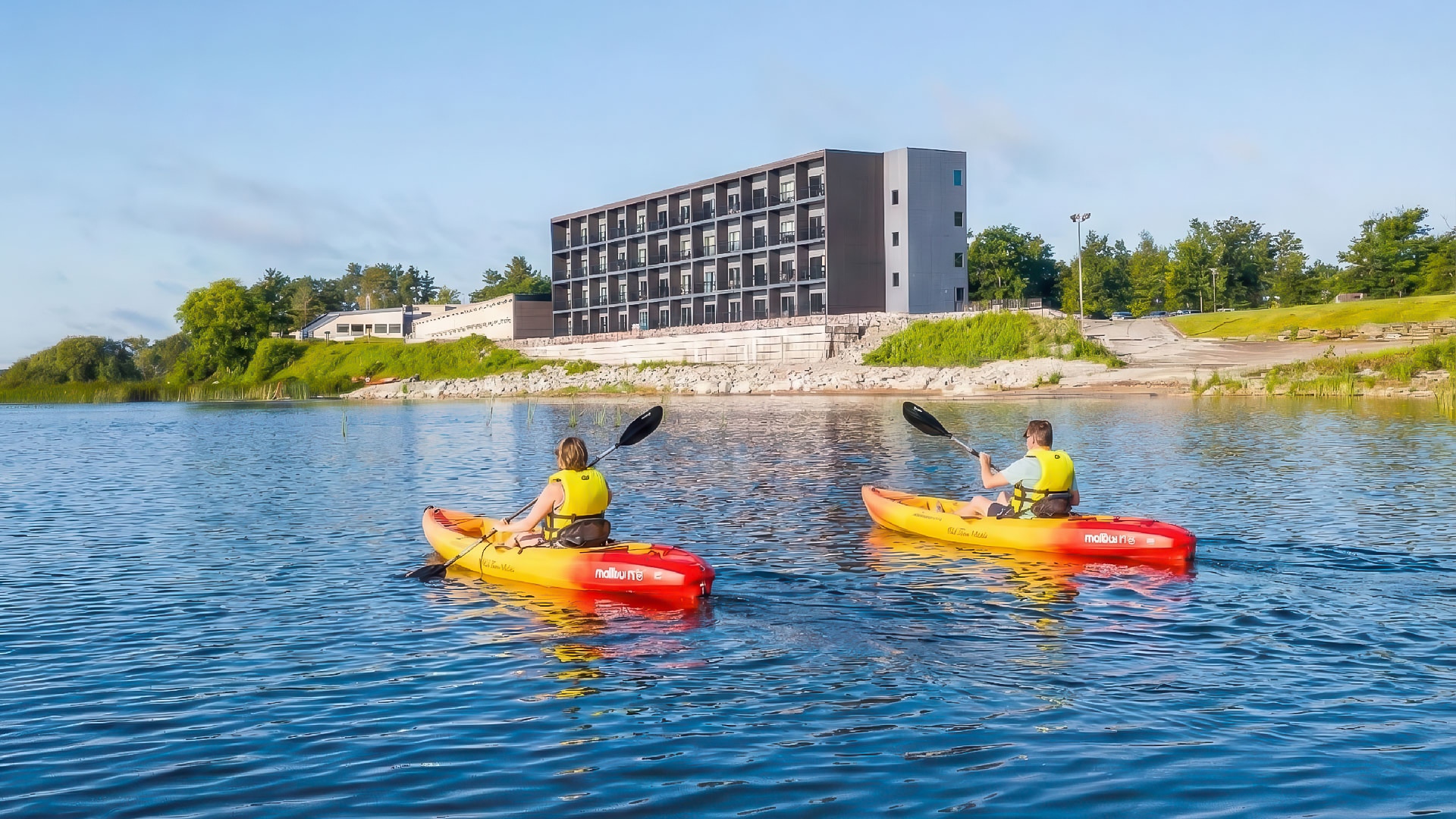 a couple of people in kayaks on a lake