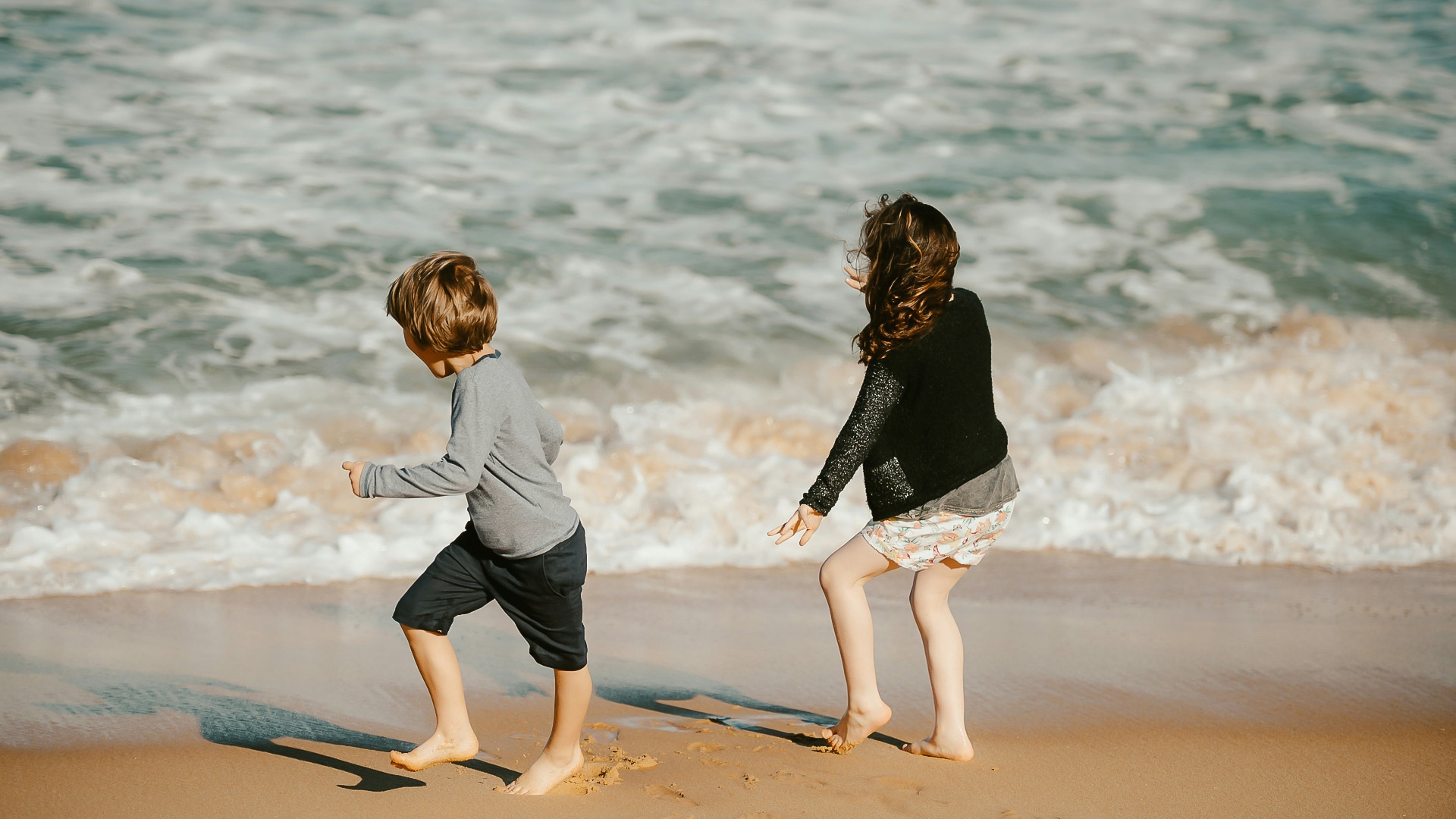 two children playing on the beach