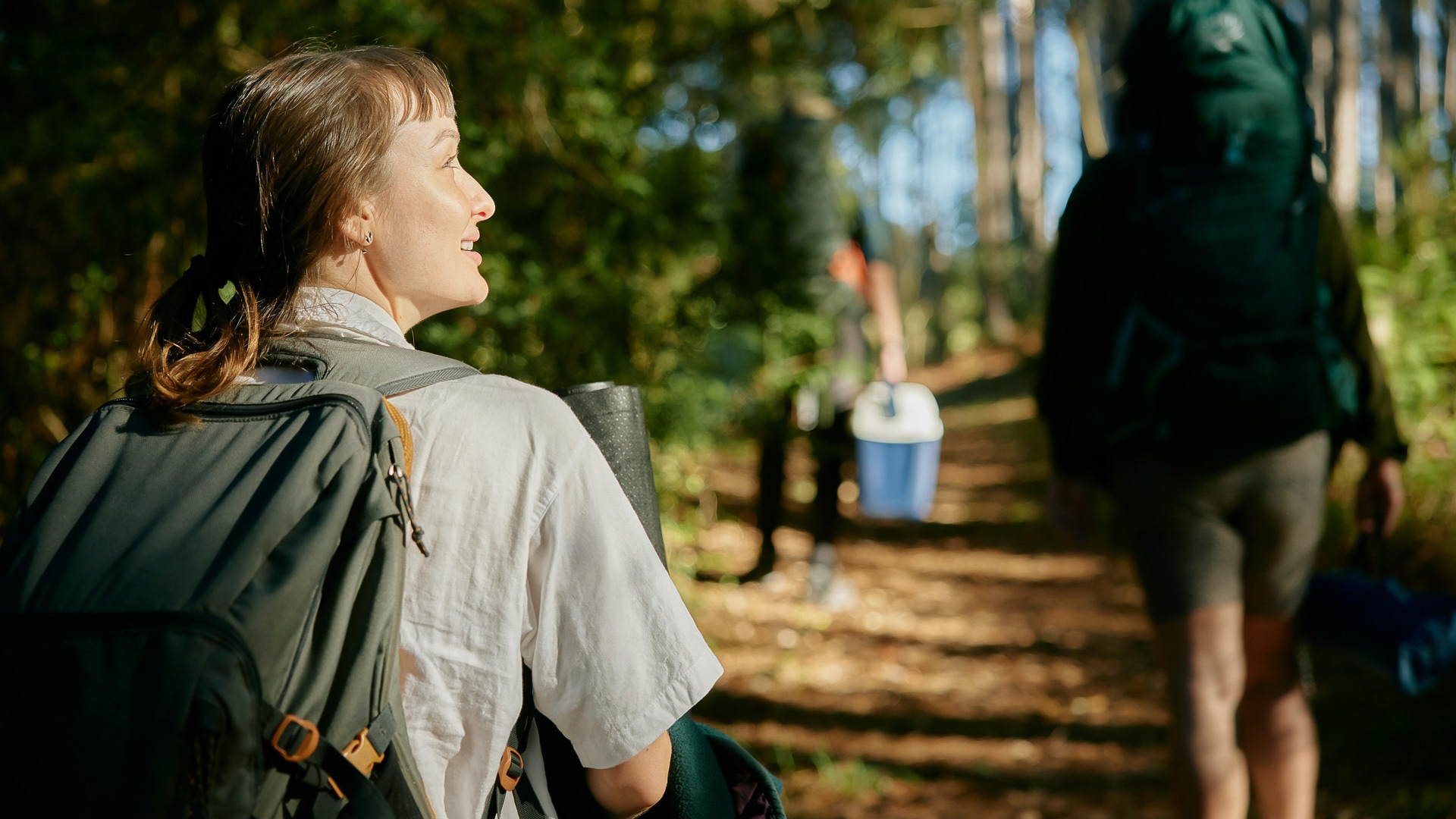 a woman with a backpack in the woods