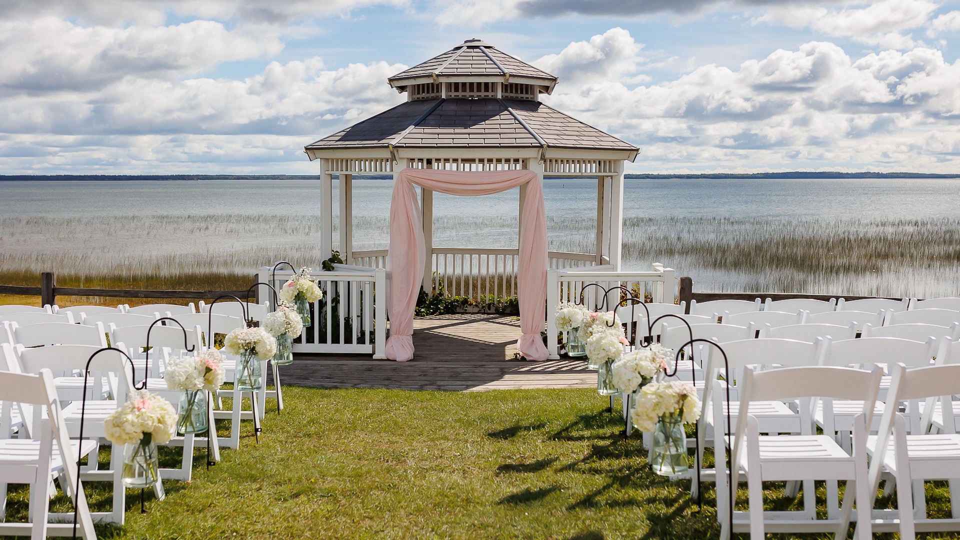 a gazebo with chairs and flowers