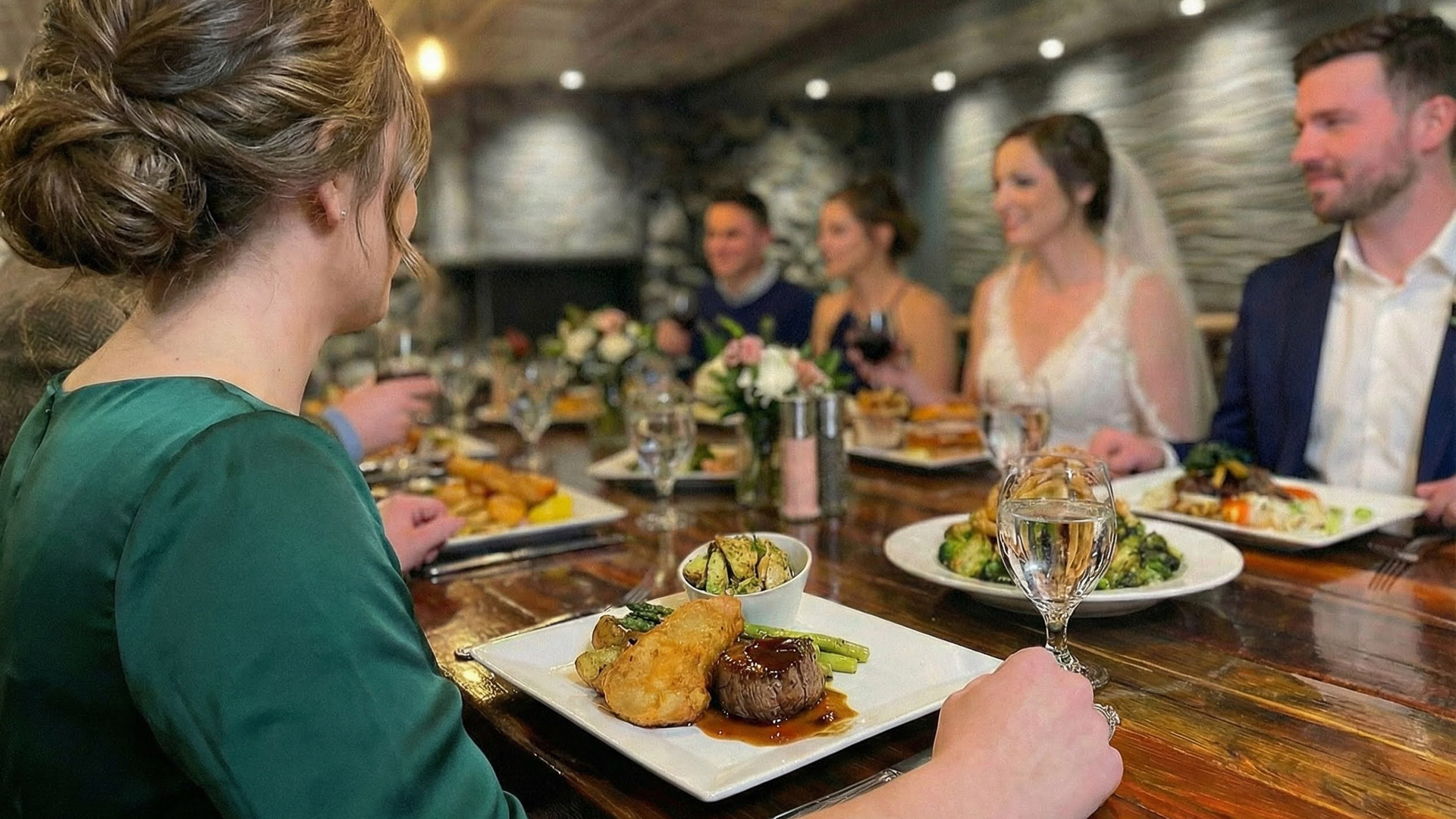 a group of people sitting at a table with food