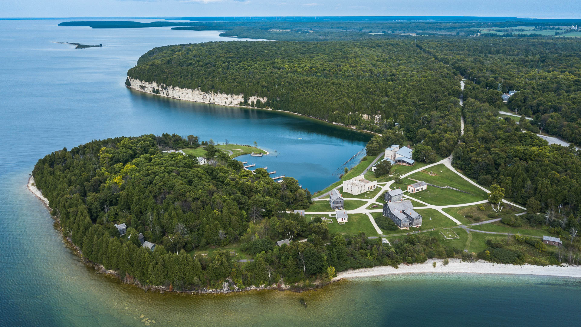 an island with a body of water and a house