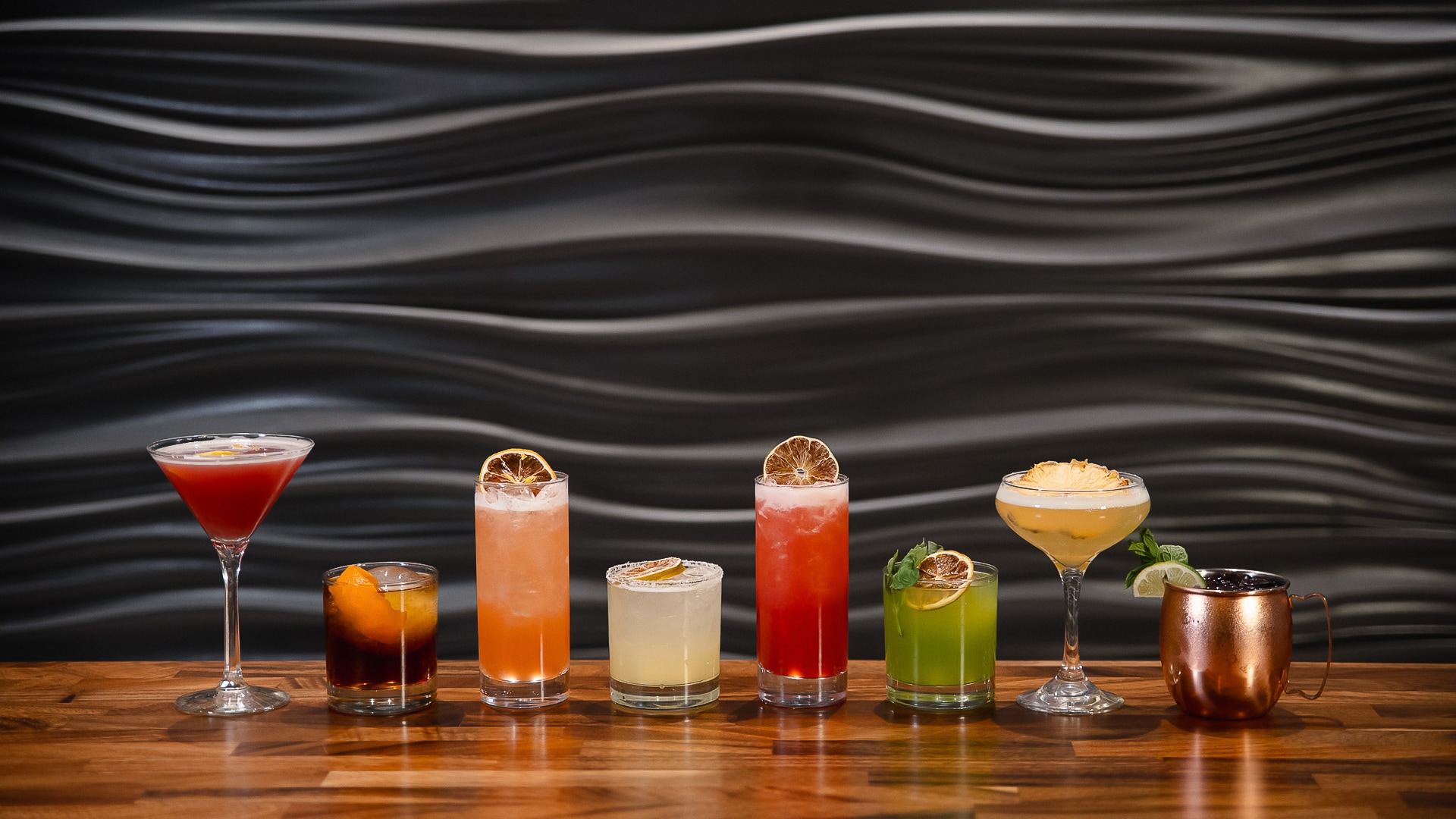 a row of different colored drinks