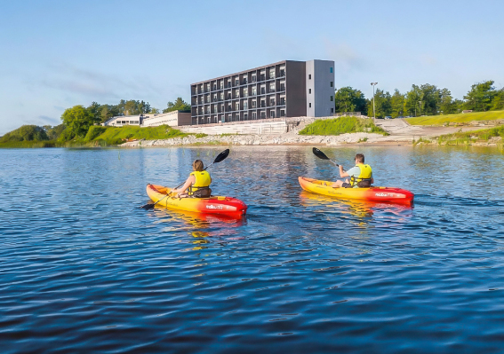 two people in kayaks on a lake