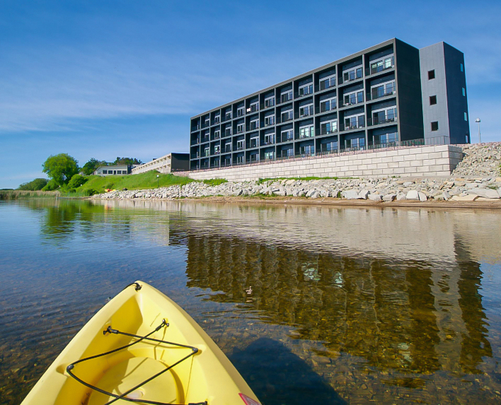 a yellow kayak on the water next to a building