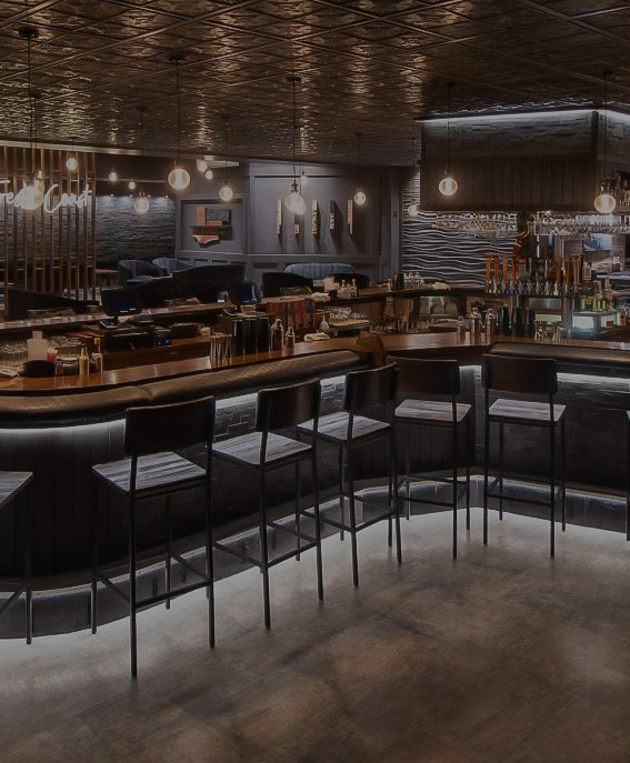 a bar with chairs and lights
