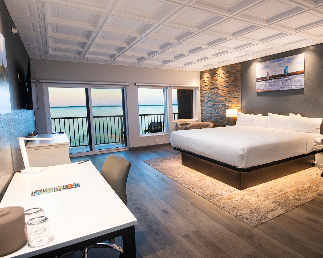 Modern hotel room with king bed and ocean view balcony