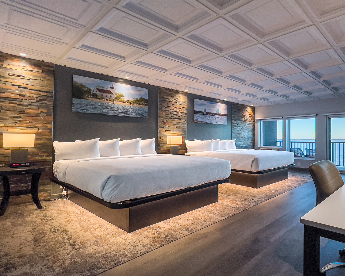 a room with two beds and a balcony