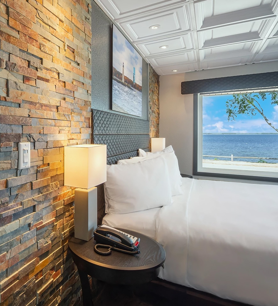 a bed with a phone and a window
