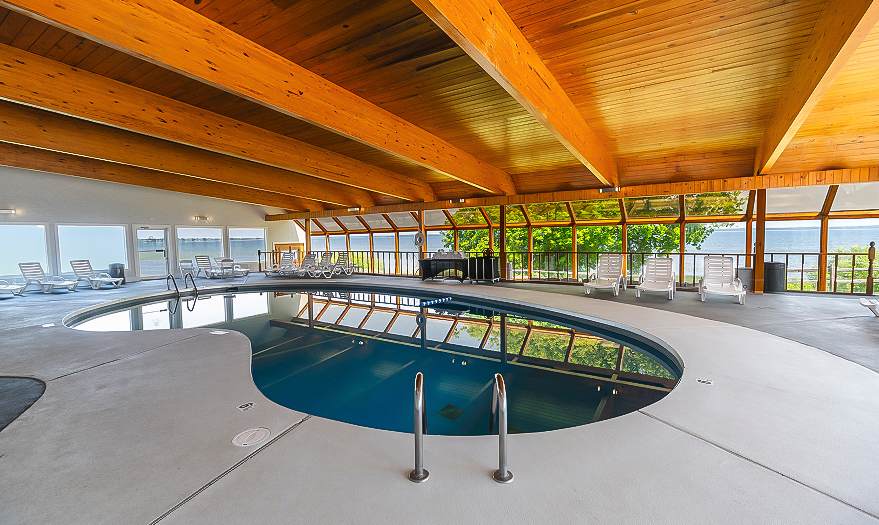a indoor pool with a wooden ceiling