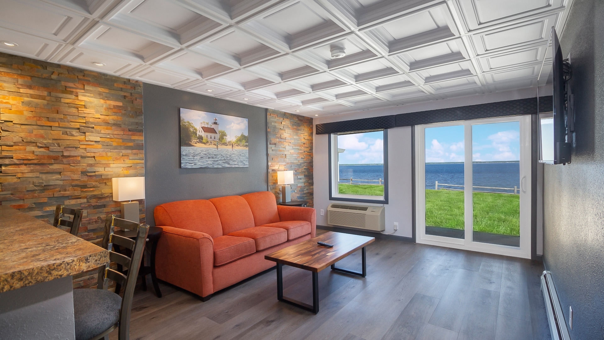 Living room with an orange sofa and water view