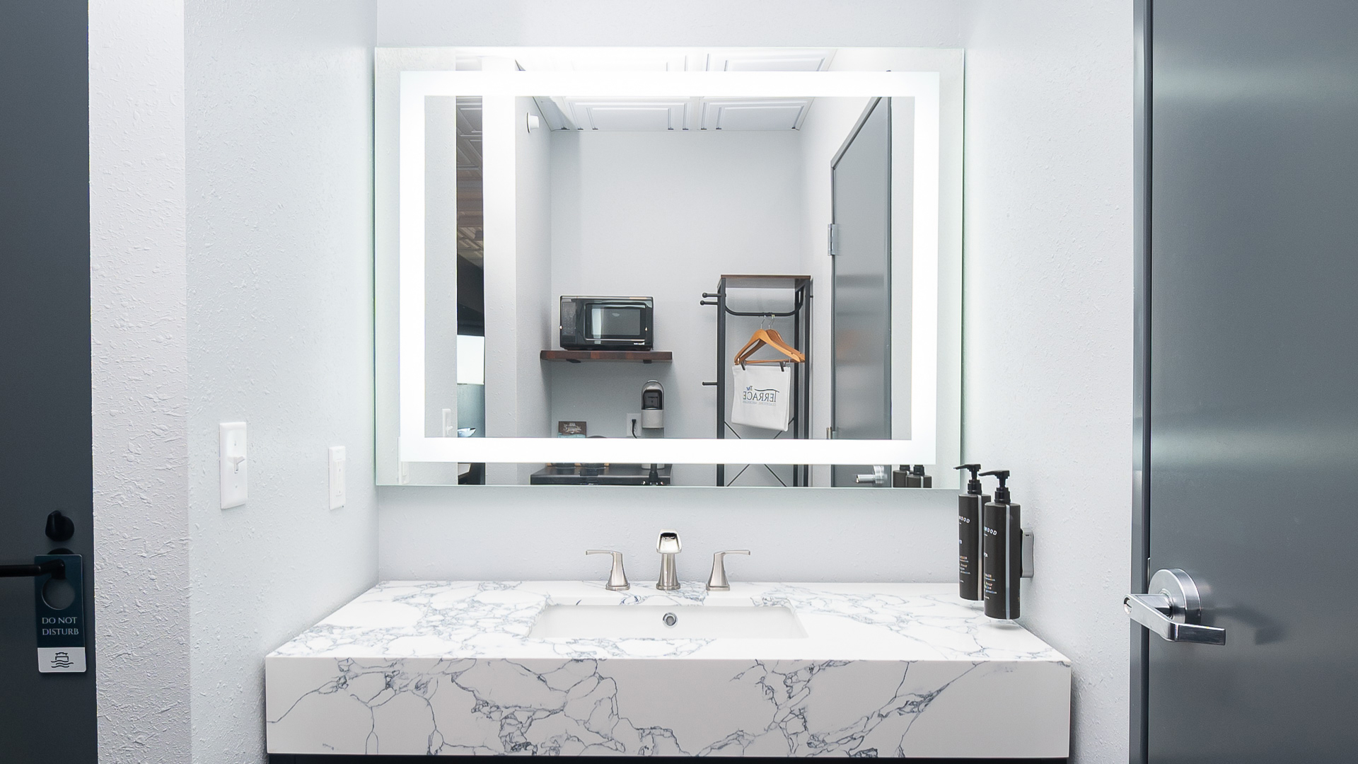 a bathroom with a mirror and a microwave