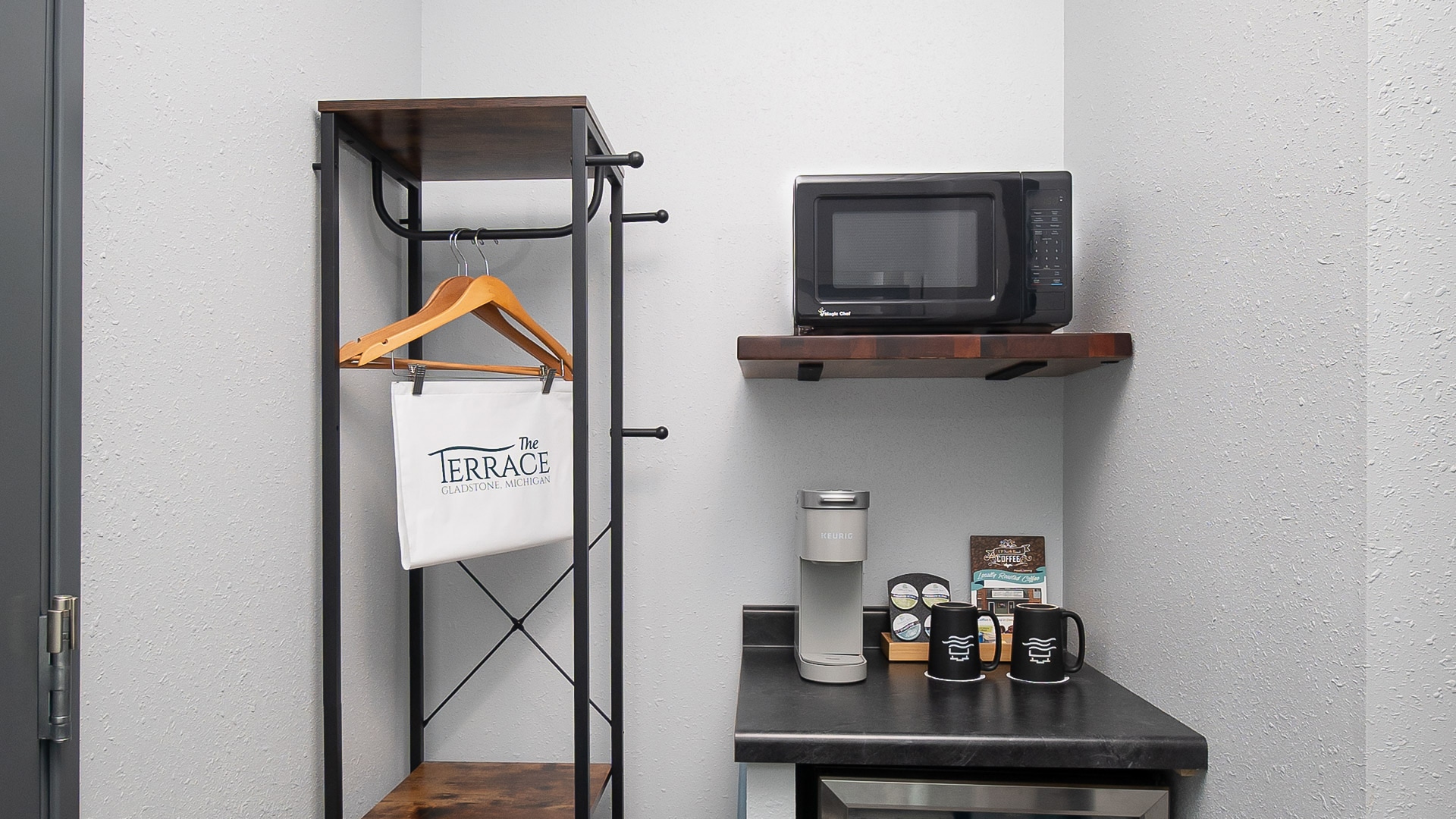 a kitchen with a microwave and coffee maker