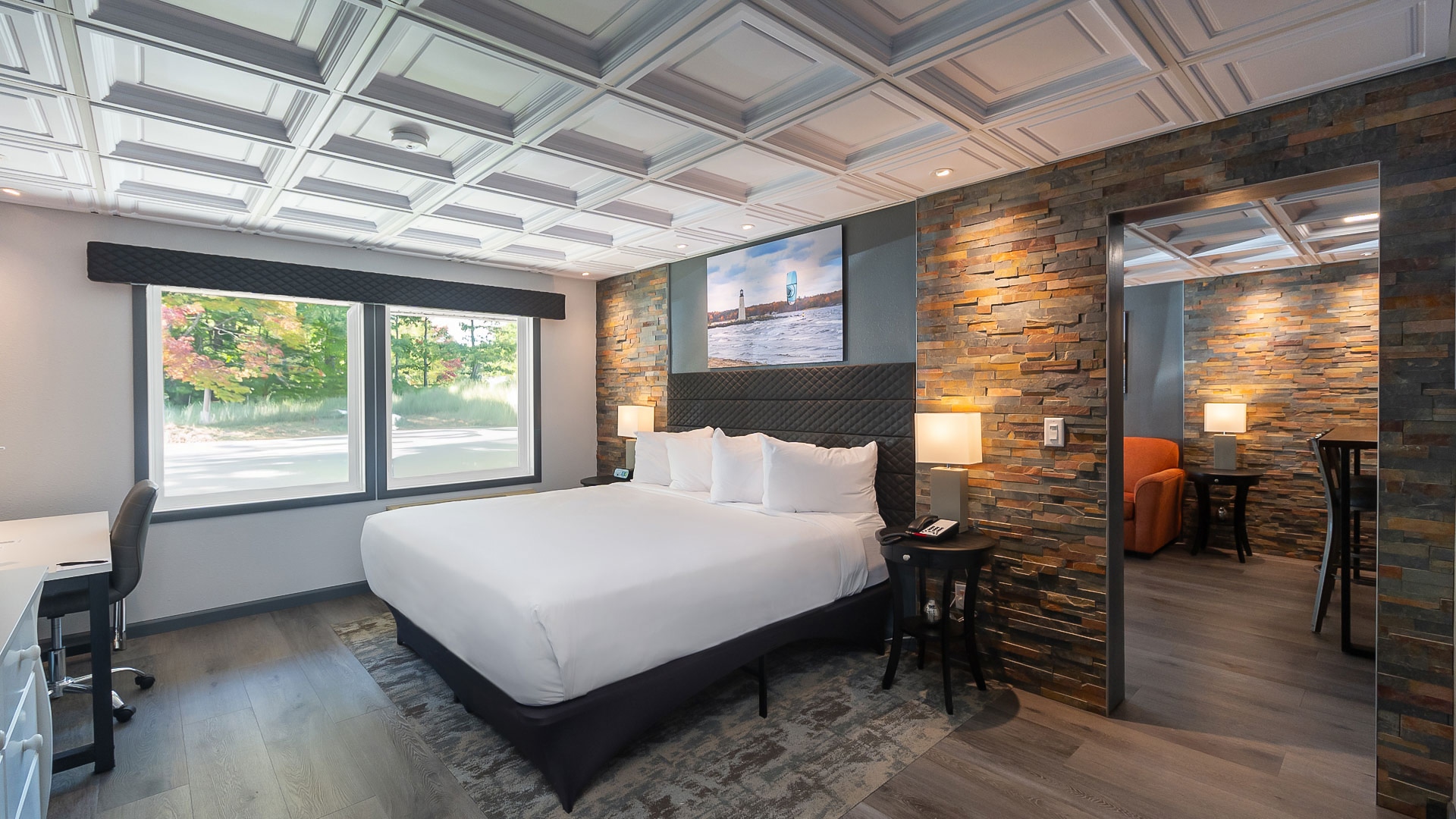 a room with a bed and a brick wall