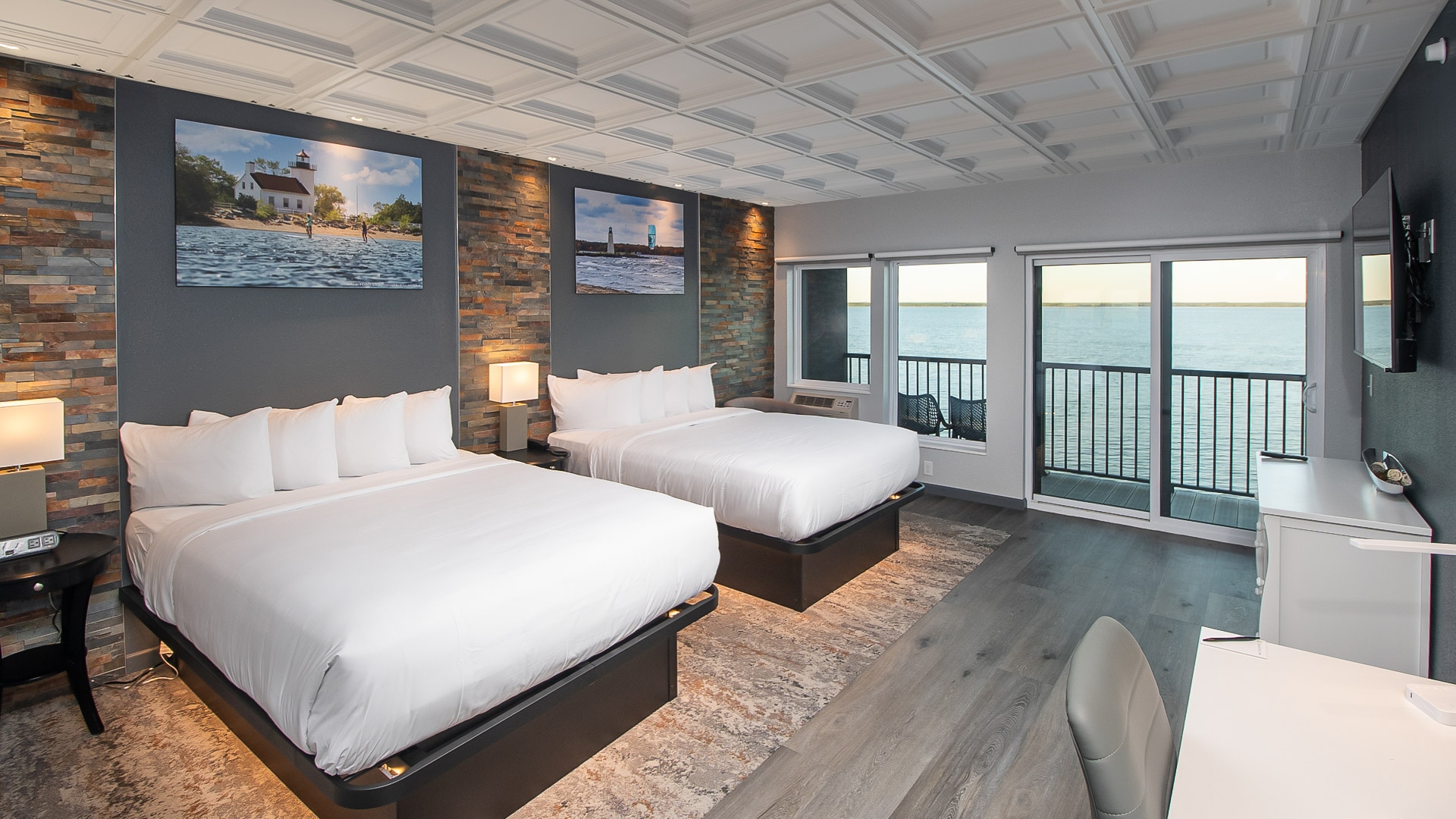 a room with two beds and a view of the ocean