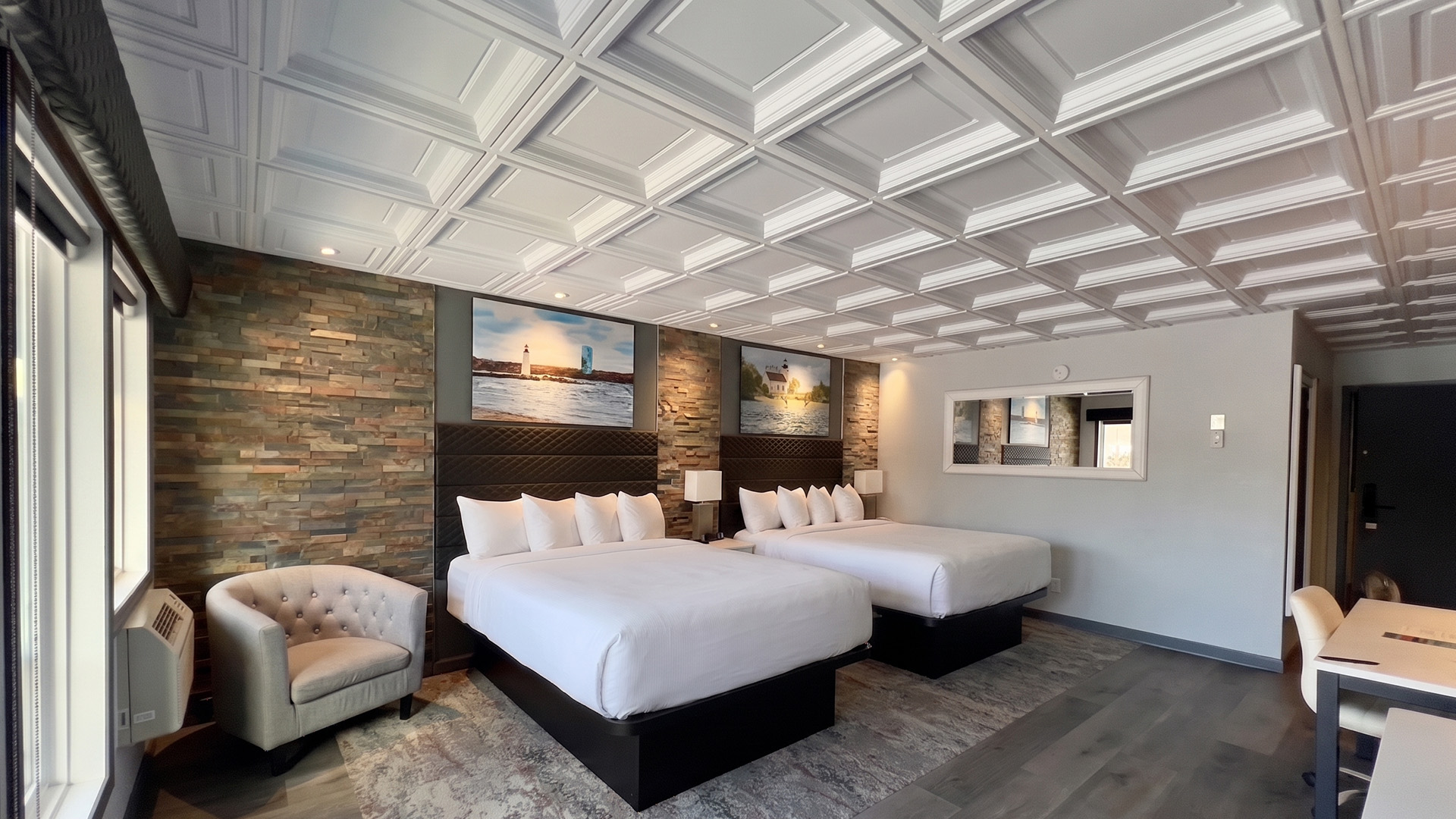 a room with two beds and a chair