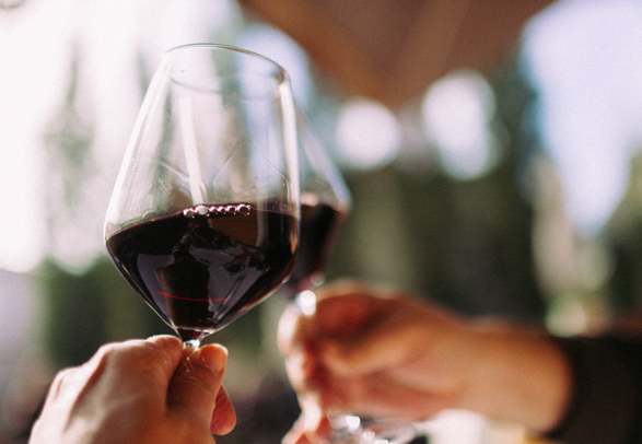 two glasses of wine being cheered