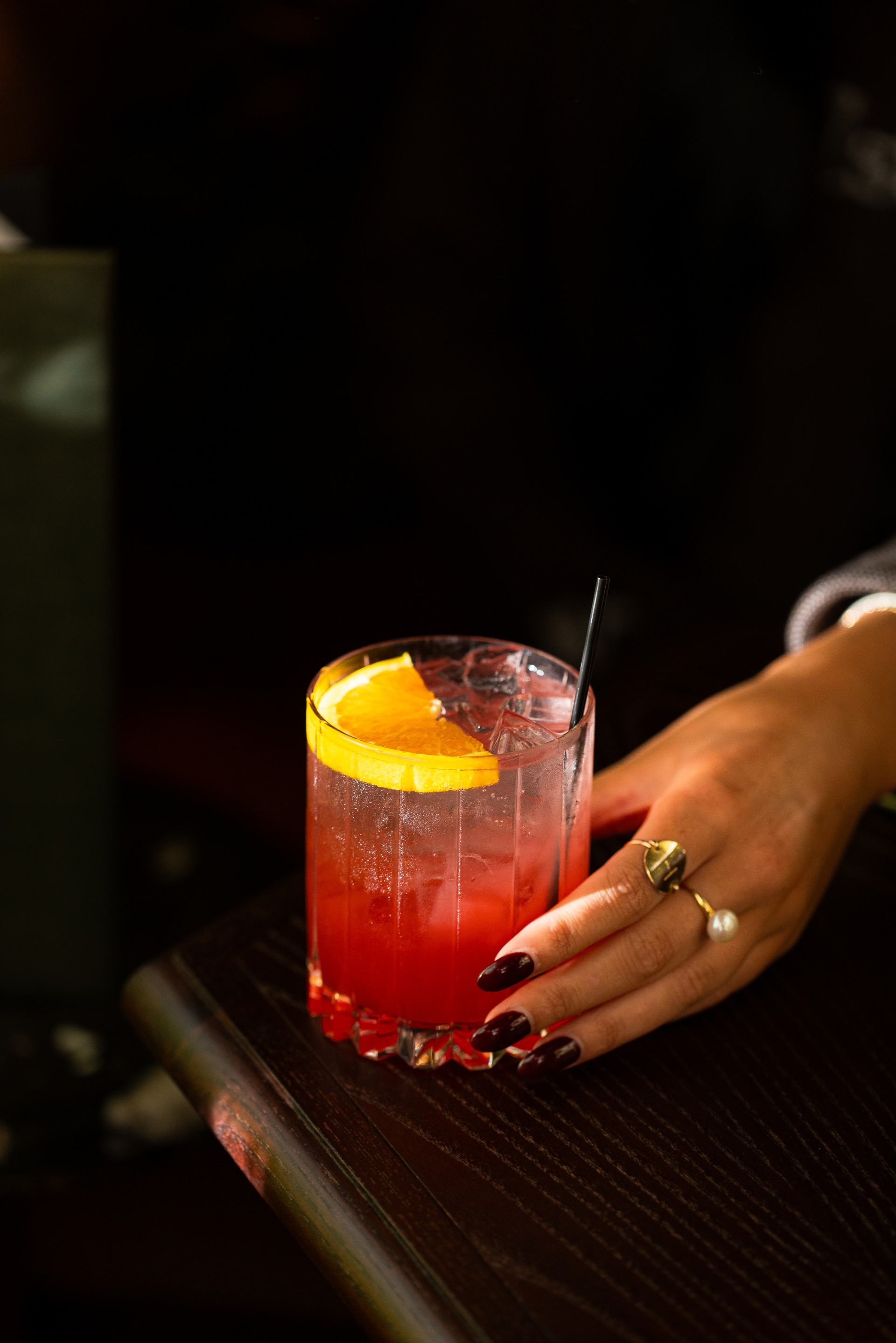 a hand holding a drink