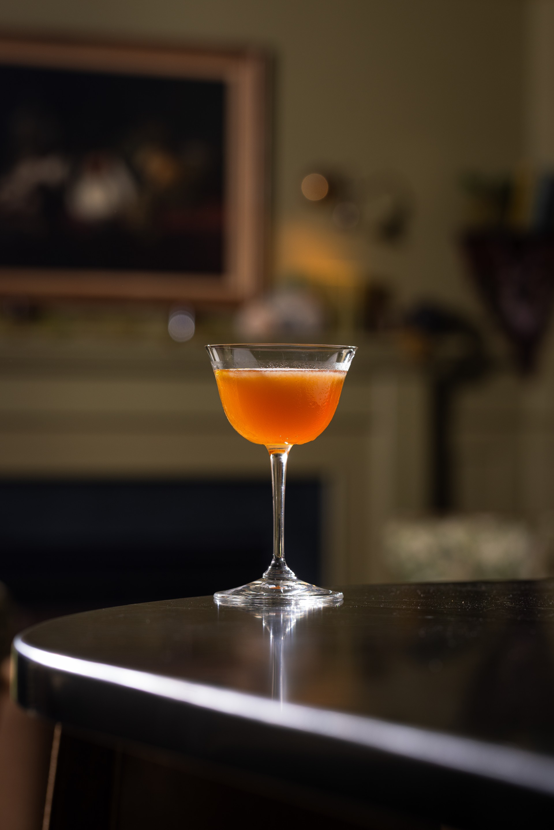 a glass of orange liquid on a table