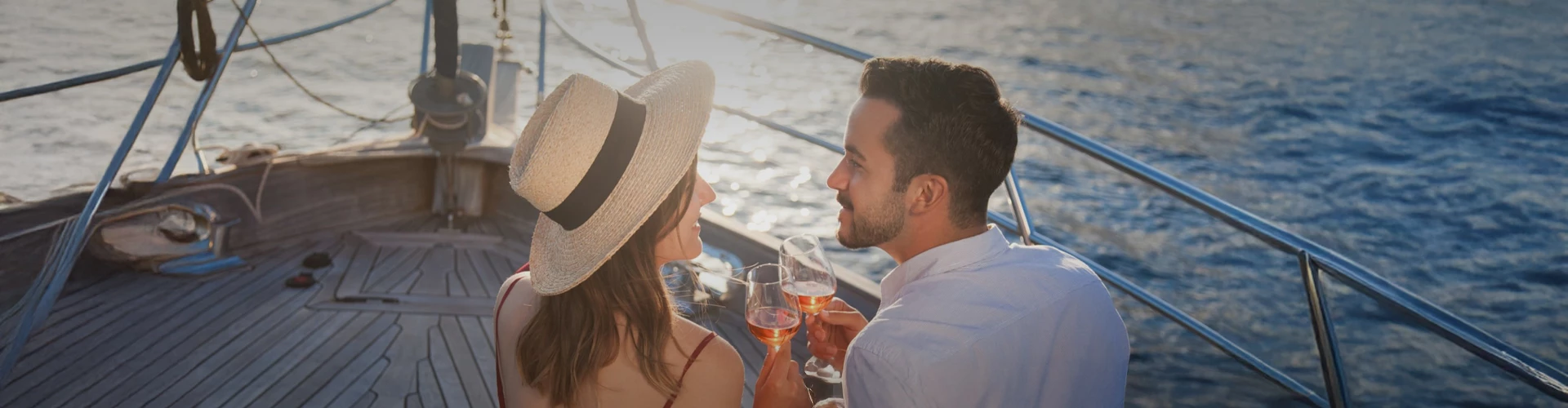 a man and woman drinking wine on a boat