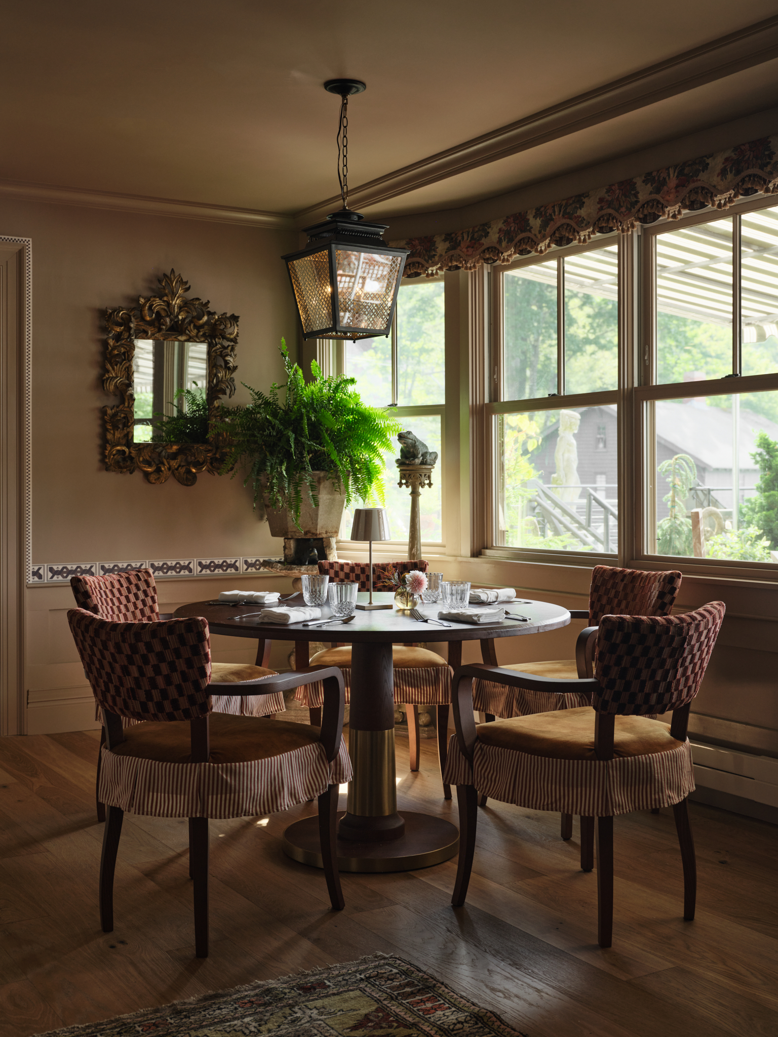 a dining table with chairs and a lamp