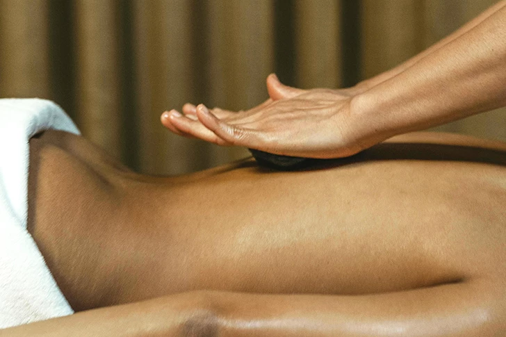 a person's hands on a person's back