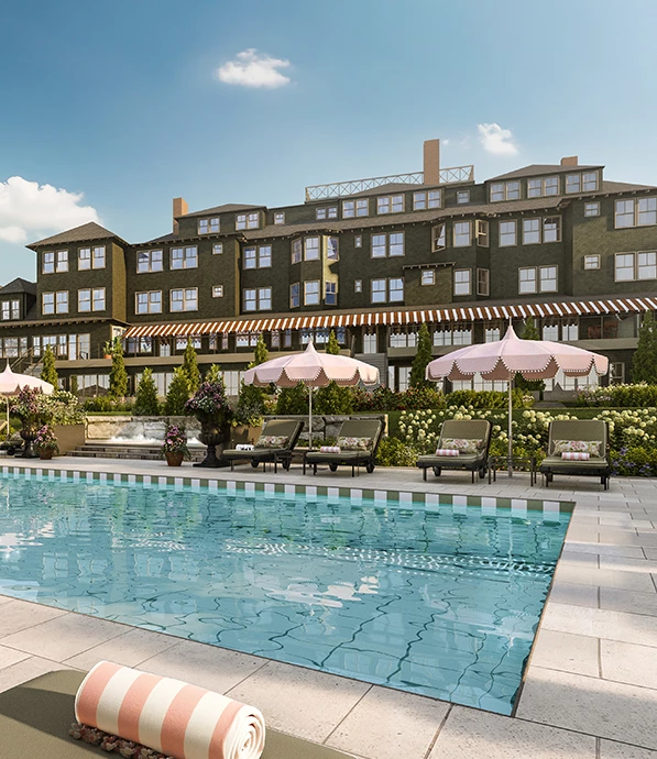 a pool with chairs and umbrellas in front of a building
