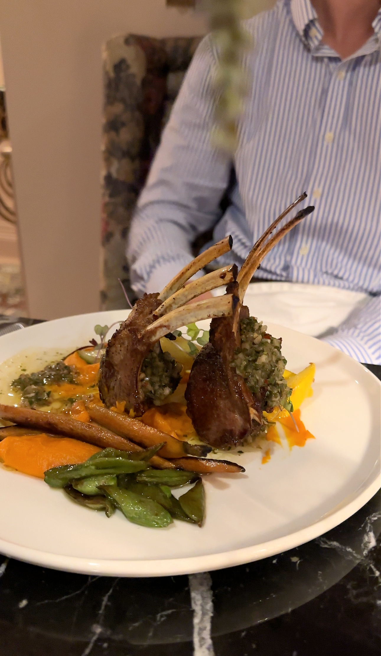 a plate of food with ribs and vegetables
