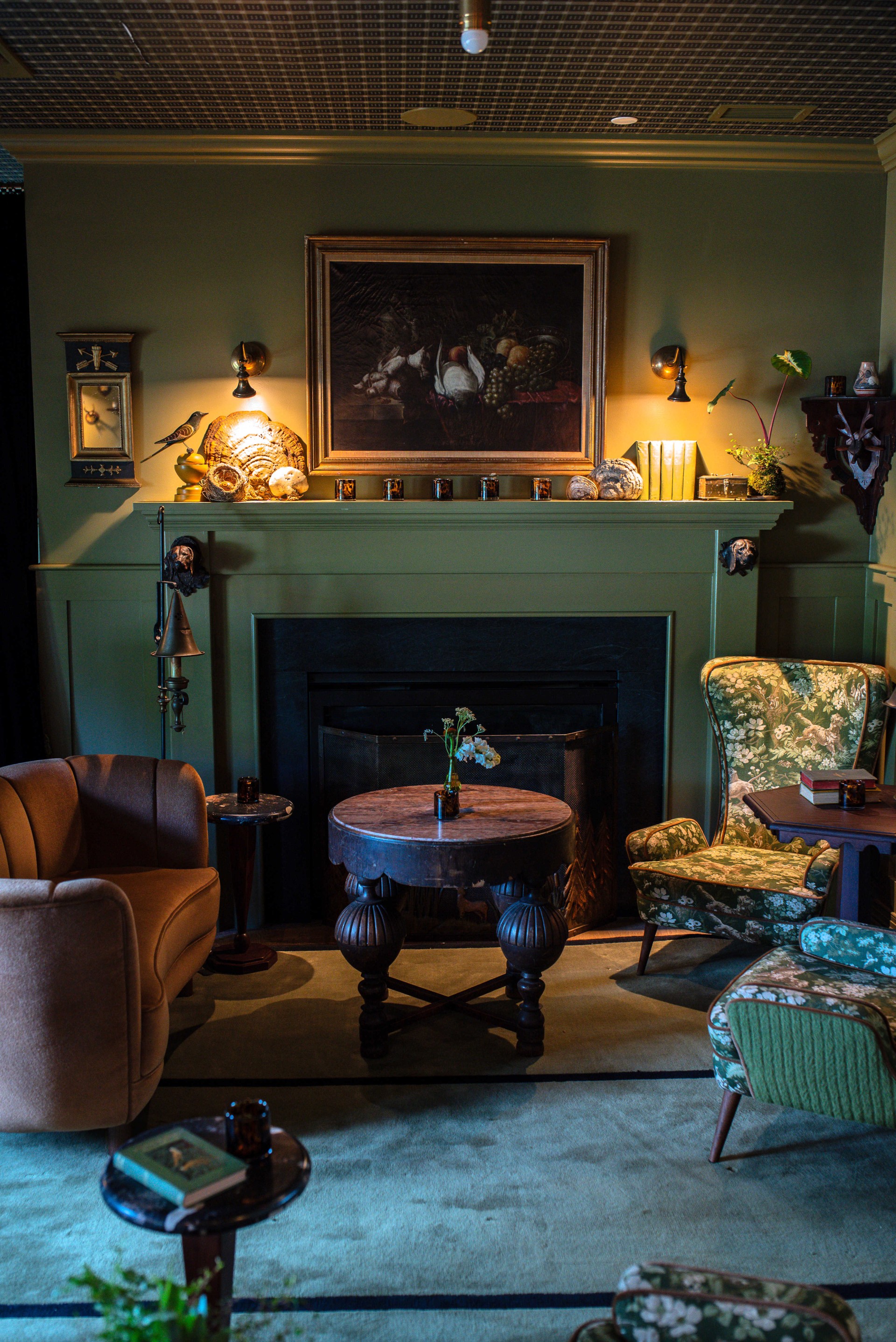 a room with a fireplace and chairs