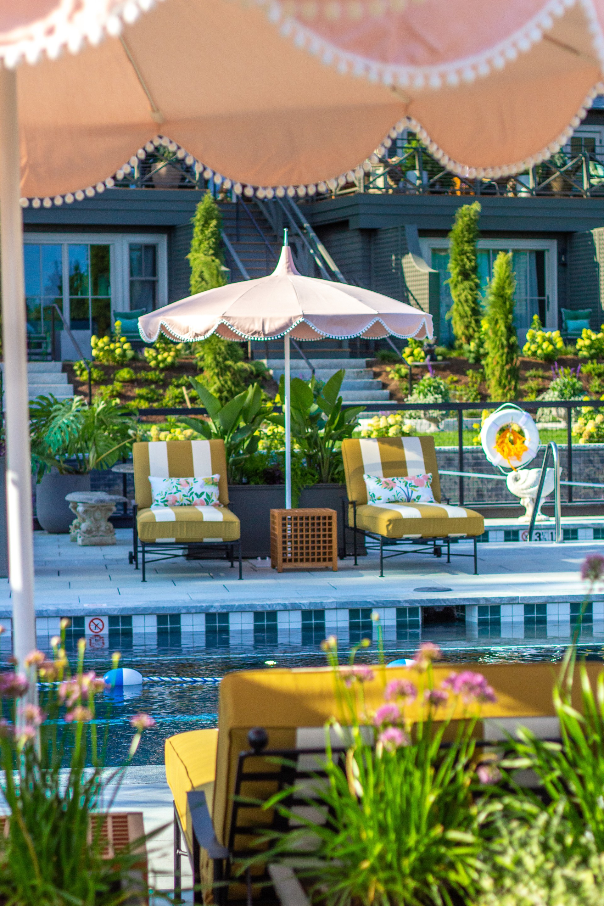 a pool with chairs and umbrella
