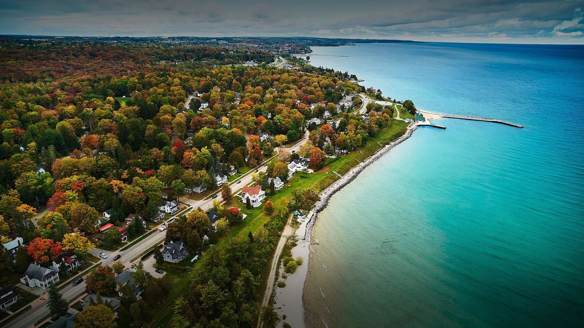 a aerial view of a road and a body of water