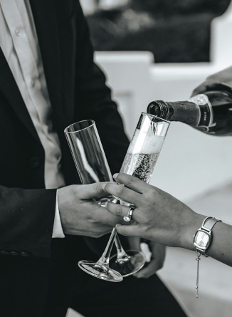 a man and woman holding champagne glasses