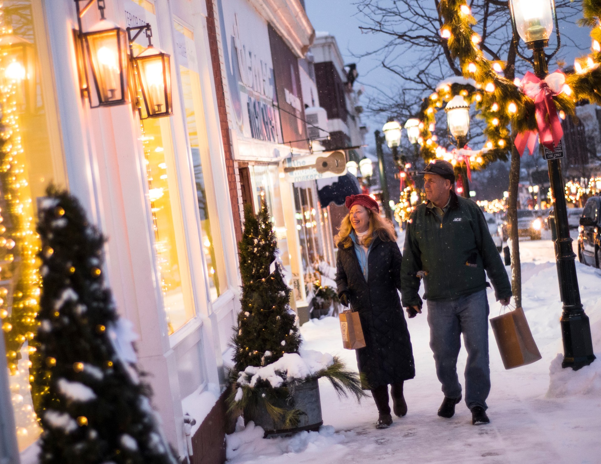 a man and woman walking down a snowy street