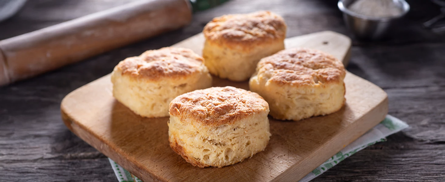 a group of biscuits on a cutting board