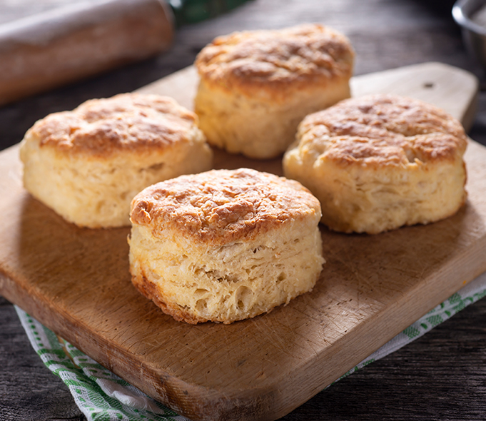 a group of biscuits on a cutting board